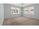 Spacious bedroom with carpet, a ceiling fan, and several windows offering ample natural light and pleasant views at 2835 Valencia S Way, St Petersburg, FL 33705