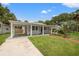 Street view of a well-maintained single-story home with covered parking and mature landscaping at 2835 Valencia S Way, St Petersburg, FL 33705