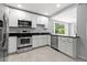 Kitchen with modern appliances, black countertops and white cabinetry at 2835 Valencia S Way, St Petersburg, FL 33705