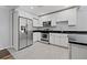Renovated kitchen with stainless steel appliances, white cabinets and light grey tiled floor at 2835 Valencia S Way, St Petersburg, FL 33705
