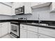 Up close kitchen view showing stainless steel appliances and white cabinets and black countertops at 2835 Valencia S Way, St Petersburg, FL 33705