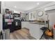 Well-equipped kitchen with a black appliance suite, white cabinets, and convenient island seating at 2835 Valencia S Way, St Petersburg, FL 33705