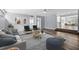 Open-concept living room featuring wood floors, stylish furnishings, and bright natural light at 2835 Valencia S Way, St Petersburg, FL 33705