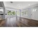 Open-concept living area with hardwood floors, large windows, and freshly painted walls at 2835 Valencia S Way, St Petersburg, FL 33705