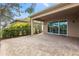 Inviting covered back patio featuring brick pavers, ideal for outdoor relaxation and entertaining at 30393 Palmer Oak Dr, Wesley Chapel, FL 33543