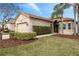 Lovely home featuring a two-car garage, manicured lawn, and stone accents around the garage at 30393 Palmer Oak Dr, Wesley Chapel, FL 33543