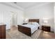 Bright main bedroom featuring a well-lit bed with side tables and an open view of an adjoining bathroom area at 30393 Palmer Oak Dr, Wesley Chapel, FL 33543