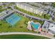 An aerial view of the pool, tennis court, and building at 4775 Cove Cir # 205, St Petersburg, FL 33708