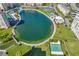 Panoramic aerial view showcasing community amenities including a large pond, tennis courts, and manicured grounds at 4775 Cove Cir # 205, St Petersburg, FL 33708