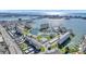 Aerial view showing the community pool, tennis courts, and the intercoastal waters in the background at 4775 Cove Cir # 205, St Petersburg, FL 33708
