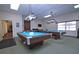 Billiards room with two billiard tables, overhead lighting and green carpet at 4775 Cove Cir # 205, St Petersburg, FL 33708