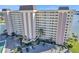 An aerial view showcases the building's facade, parking, landscaping, and inviting entrance at 4775 Cove Cir # 205, St Petersburg, FL 33708