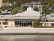 Exterior view of a community building with covered patio, seating, and waterfront access at 4775 Cove Cir # 205, St Petersburg, FL 33708