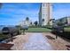 Community grilling area with well-kept landscaping, putting green and seating at 4775 Cove Cir # 205, St Petersburg, FL 33708