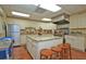 Large kitchen with stainless steel appliances, granite countertops, and a center island with bar stools at 4775 Cove Cir # 205, St Petersburg, FL 33708