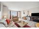 Comfortable living area with hardwood floors, a neutral color scheme, and an abundance of natural light at 4775 Cove Cir # 205, St Petersburg, FL 33708