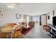 Bright living room with hardwood floors, plush seating, and large windows for natural light at 4775 Cove Cir # 205, St Petersburg, FL 33708