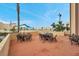 Expansive outdoor patio with several tables and chairs, perfect for entertaining guests at 4775 Cove Cir # 205, St Petersburg, FL 33708