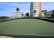 Community putting green and lush, manicured landscaping for a relaxing recreational space at 4775 Cove Cir # 205, St Petersburg, FL 33708