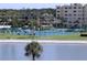 Waterfront tennis court surrounded by lush landscaping, providing an active and scenic community space at 4775 Cove Cir # 205, St Petersburg, FL 33708
