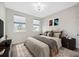 Staged bedroom features a large window and cozy furnishings at 5080 Avalon Park Blvd, Wesley Chapel, FL 33545