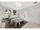 Cozy bedroom with large bed, soft carpet, modern fixtures and a tranquil color scheme at 5080 Avalon Park Blvd, Wesley Chapel, FL 33545