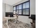 Bright home office with a big window, dark shutters, a modern desk and comfortable chair on a soft rug at 5080 Avalon Park Blvd, Wesley Chapel, FL 33545