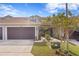 Exterior view of a townhome with a two-car garage and landscaping at 5286 Neil Dr, St Petersburg, FL 33714