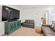 Comfortable living area with a large TV, modern cabinet, and neutral carpet at 5286 Neil Dr, St Petersburg, FL 33714