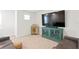 Cozy seating area with a large screen TV, modern console, and comfortable sofa at 5286 Neil Dr, St Petersburg, FL 33714