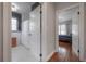 Bathroom featuring tiled walls and floors, a shower with a white curtain, and an open view to the bedroom at 5502 N 9Th St, Tampa, FL 33604