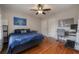 Spacious bedroom featuring hardwood floors, ceiling fan, and ample natural light from large windows at 5502 N 9Th St, Tampa, FL 33604