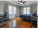 Sunny bedroom with hardwood floors, large windows, stylish curtains, and a comfortable work space at 5502 N 9Th St, Tampa, FL 33604