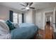 A well-lit bedroom with a ceiling fan, wood floors, and a closet at 5502 N 9Th St, Tampa, FL 33604
