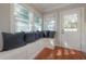 Inviting breakfast nook with built-in bench, plush pillows, natural light, and a glass panel entry door at 5502 N 9Th St, Tampa, FL 33604