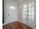 A well-lit foyer with a glass paned door and beautiful wood floors at 5502 N 9Th St, Tampa, FL 33604
