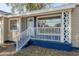 Charming front porch with decorative white railing and brick foundation at 5502 N 9Th St, Tampa, FL 33604