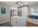 Modern kitchen featuring stainless steel appliances, white cabinets, and a center island at 5502 N 9Th St, Tampa, FL 33604