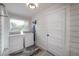 A bright laundry room with an ironing board, washer, and dryer at 5502 N 9Th St, Tampa, FL 33604