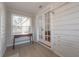 A sun room with a window, a writing desk, and white paneled walls at 5502 N 9Th St, Tampa, FL 33604