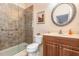Bathroom featuring a walk-in shower, single sink vanity, and stylish round mirror at 6214 45Th E Ln, Bradenton, FL 34203