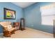 Bedroom with blue walls, a total gym system, chair and natural light from window at 6214 45Th E Ln, Bradenton, FL 34203