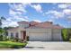 Charming single-story home featuring a clay tile roof, three-car garage, and a well-manicured lawn at 6214 45Th E Ln, Bradenton, FL 34203