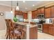 Elegant kitchen with stainless steel appliances, granite countertops, and a breakfast bar with wooden stools at 6214 45Th E Ln, Bradenton, FL 34203