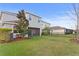 Spacious backyard with lush green grass, mature landscaping, and a privacy fence at 6219 Voyagers Pl, Apollo Beach, FL 33572