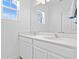 Bathroom featuring a double sink with a quartz countertop and a large mirror at 6219 Voyagers Pl, Apollo Beach, FL 33572