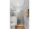 Elegant bathroom shower with gray tiled walls, glass enclosure, and modern fixtures at 6219 Voyagers Pl, Apollo Beach, FL 33572