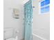 Clean bathroom featuring a shower with a blue curtain with a floral pattern at 6219 Voyagers Pl, Apollo Beach, FL 33572