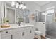 Stylish bathroom featuring a white vanity, decorative mirror, and glass-enclosed shower with tiled walls at 6219 Voyagers Pl, Apollo Beach, FL 33572