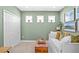 Cozy bedroom with natural light, neutral walls, and comfortable seating at 6219 Voyagers Pl, Apollo Beach, FL 33572
